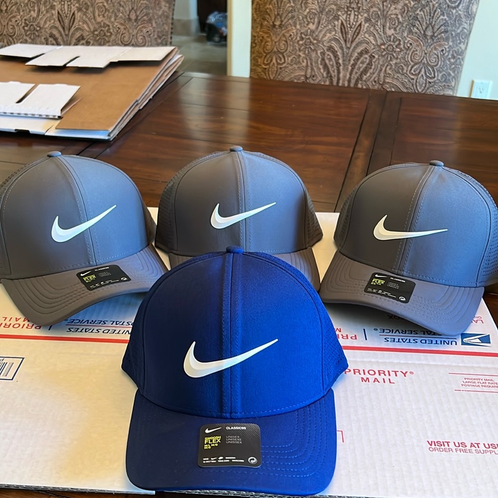 Private listing. 3 charcoal gray and one blue Nike Classic 99 hats.